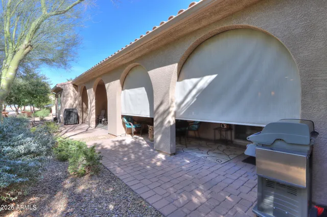 a view of backyard with a tub and a large tree