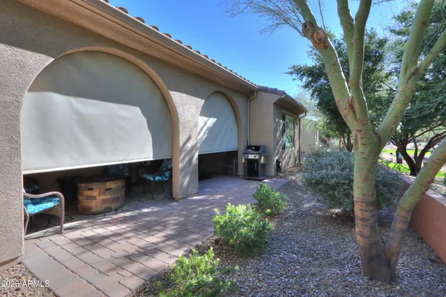 a view of backyard with a table and chairs