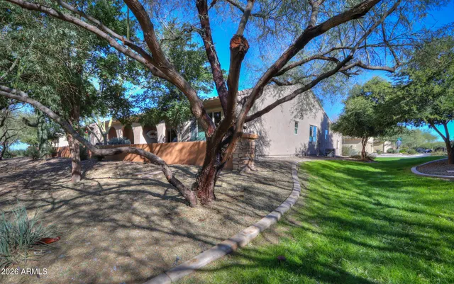 a backyard of a house with large trees