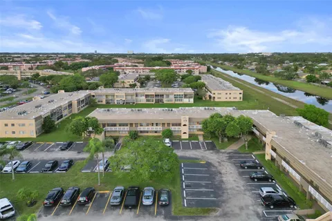 an aerial view of a house with a garden and lake view