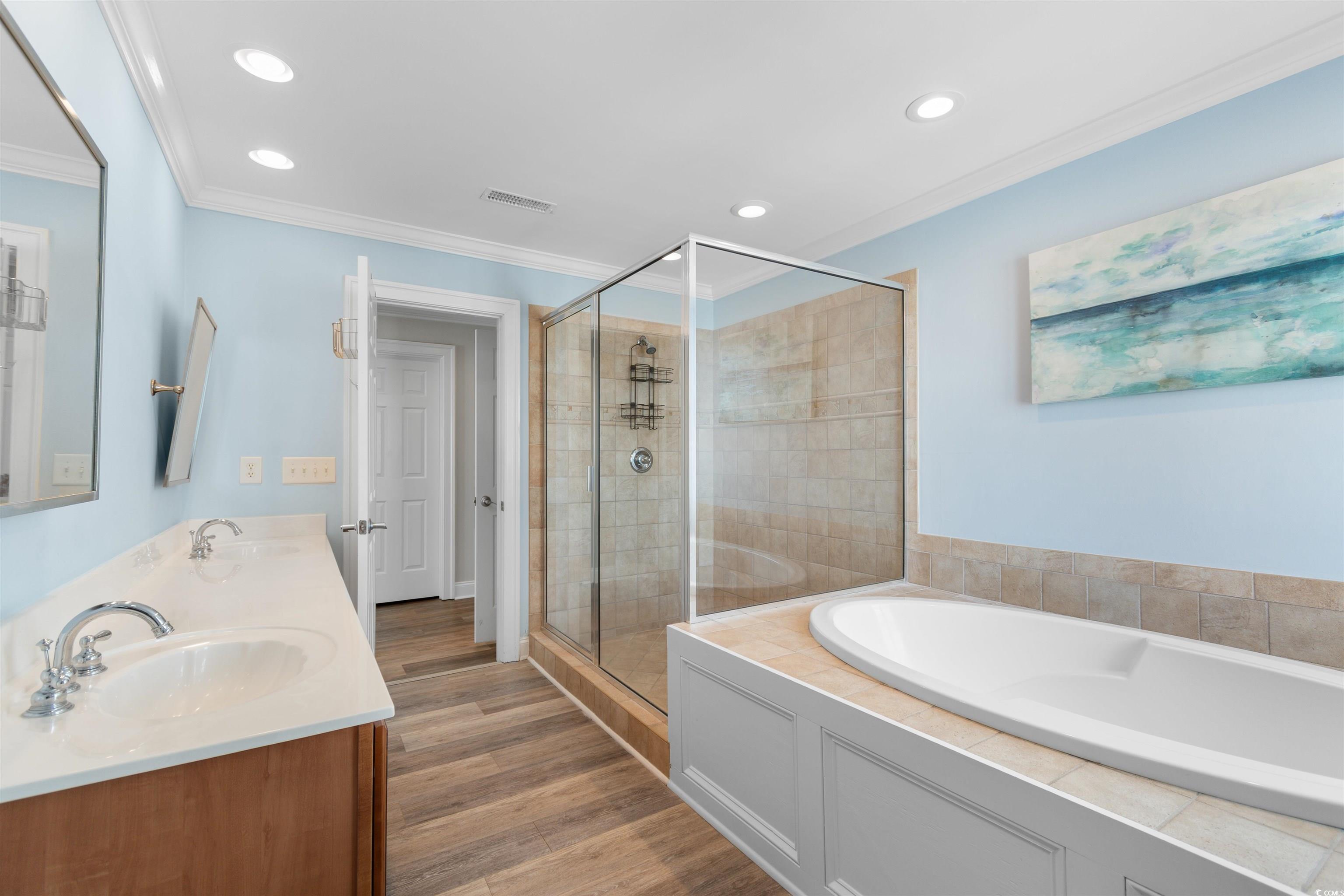 703 South Waccamaw Drive Murrells Inlet, SC 29576 - Photo 27 of 40 Primary En-Suite Full bathroom featuring a tile shower, garden jetted tub, and double vanity