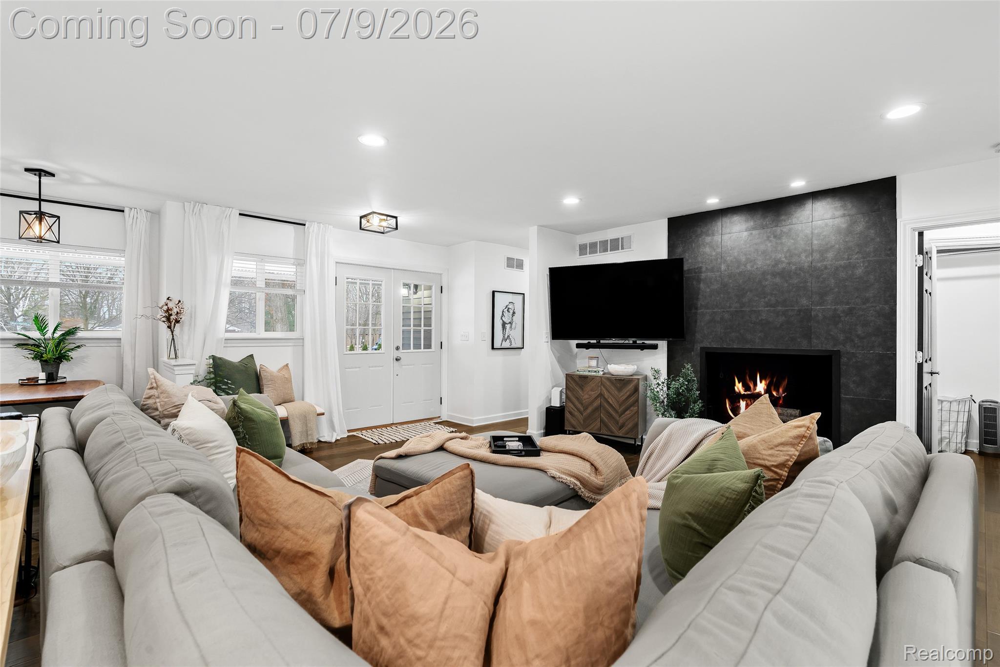 2566 Harrington Road Rochester, MI 48307 - Photo 19 of 64 Living room featuring oversized sectional, 65" Smart TV, hardwood floors and recessed lighting