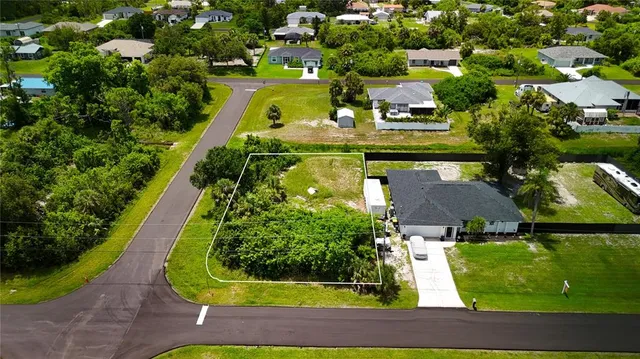 an aerial view of a house with garden space ocean view