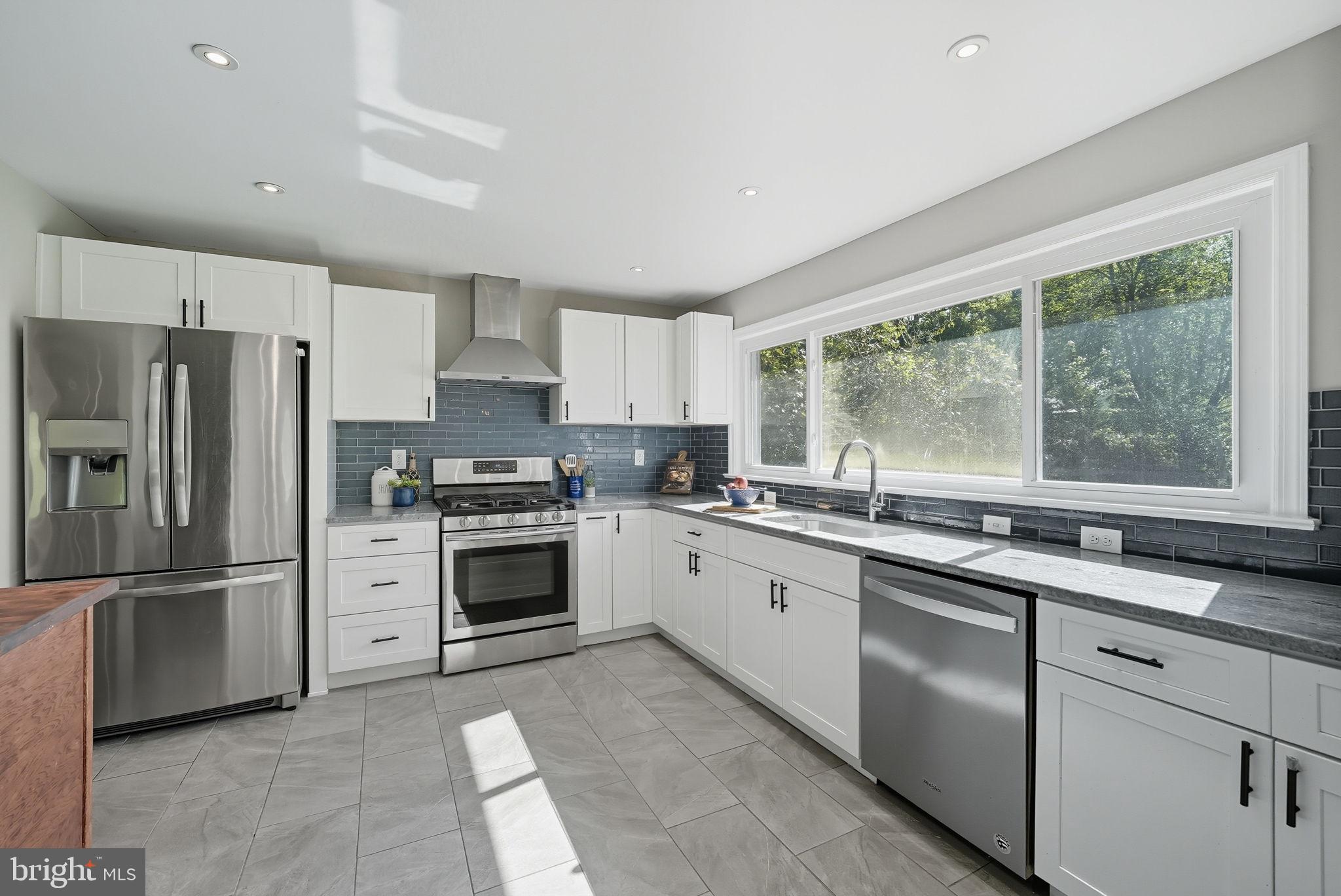 5209 Cedar Road Alexandria, VA 22309 - Photo 12 of 42 a kitchen with a sink stove and refrigerator