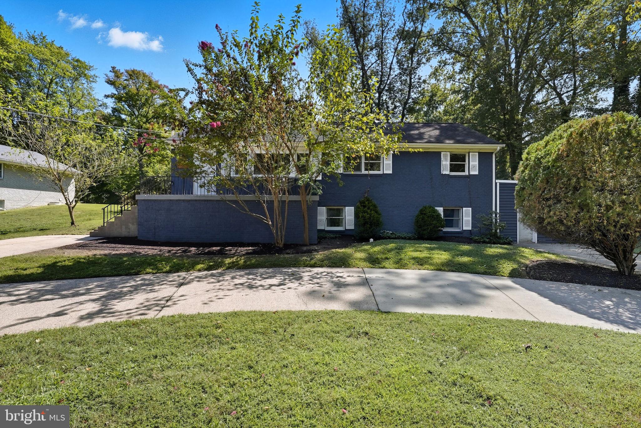 5209 Cedar Road Alexandria, VA 22309 - Photo 2 of 42 a front view of a house with a yard