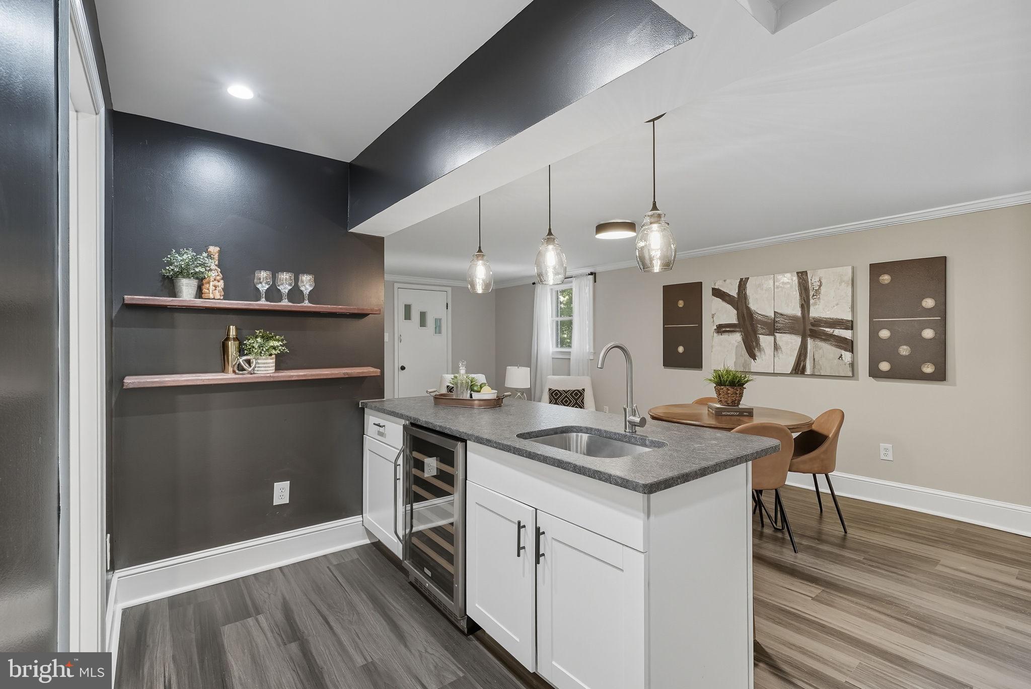 5209 Cedar Road Alexandria, VA 22309 - Photo 23 of 42 a kitchen with a sink a counter space appliances and cabinets