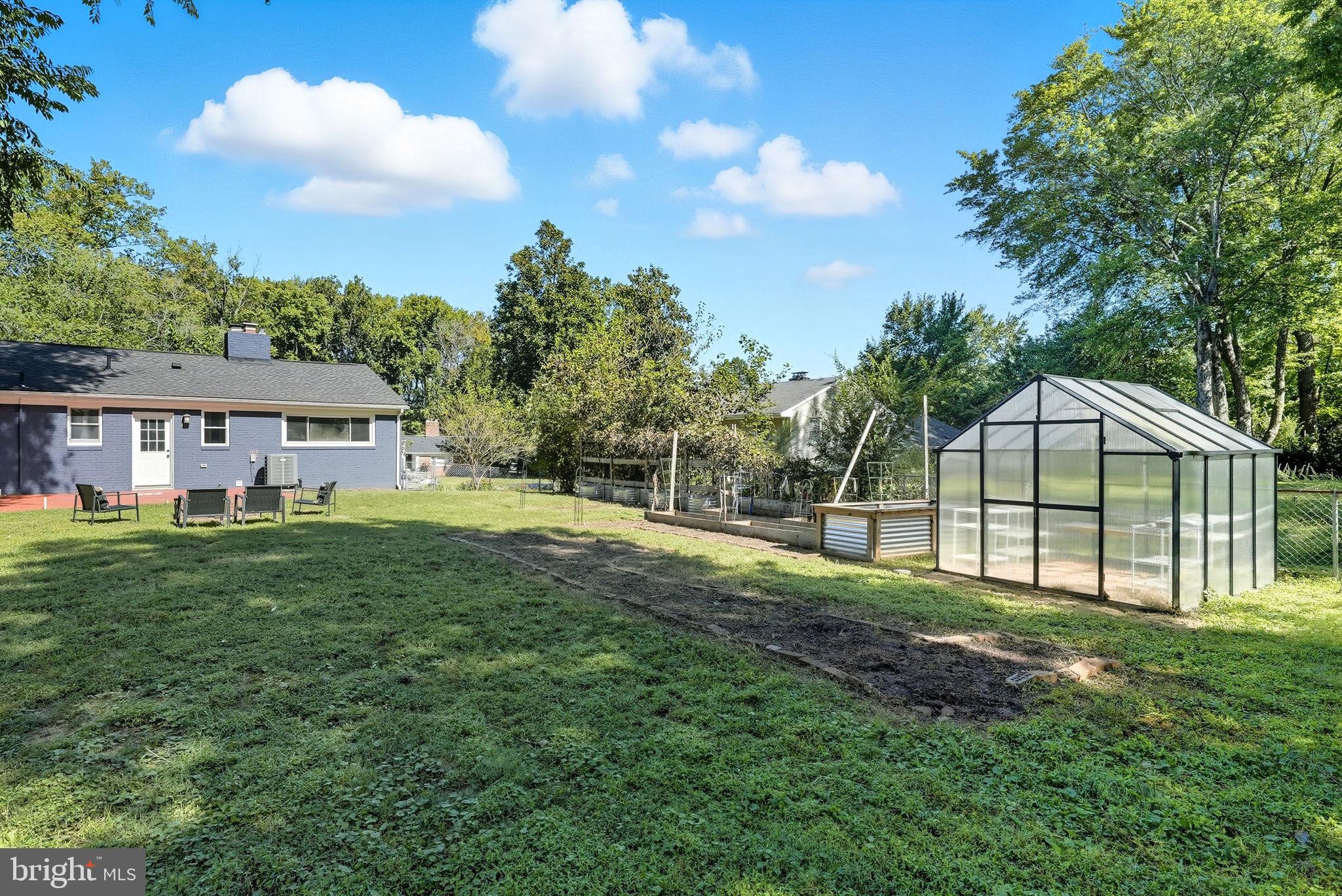 5209 Cedar Road Alexandria, VA 22309 - Photo 35 of 42 a view of a house with yard and a garden