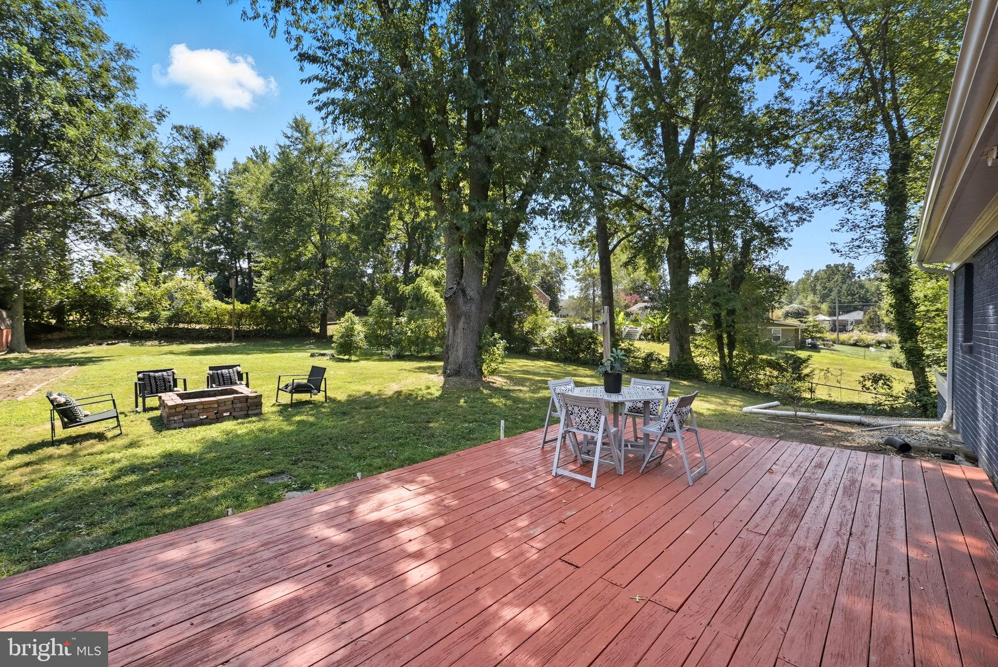 5209 Cedar Road Alexandria, VA 22309 - Photo 36 of 42 a view of a table and chair on the wooden deck