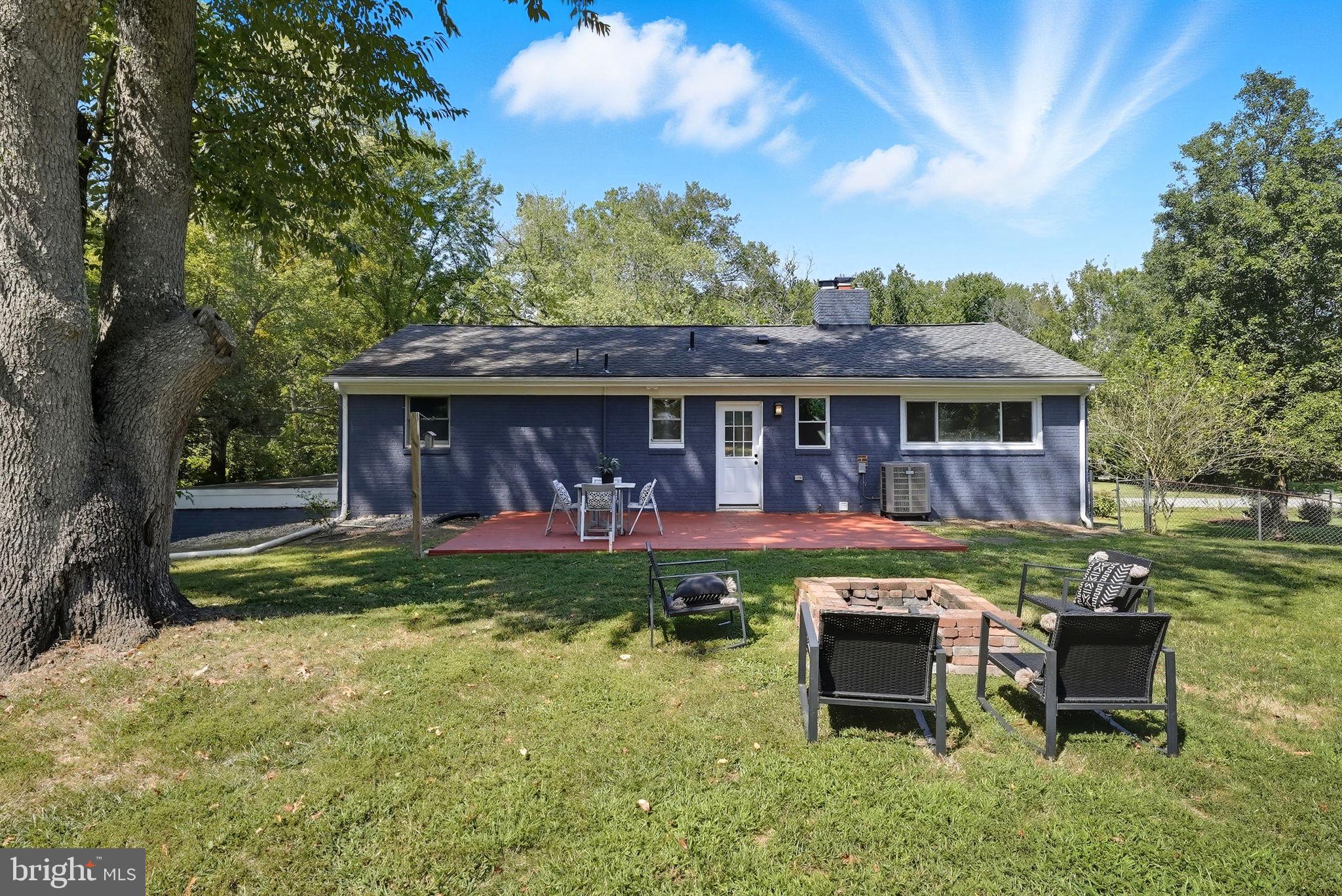 5209 Cedar Road Alexandria, VA 22309 - Photo 38 of 42 a front view of a house with a yard table and chairs