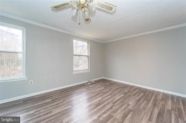 wooden floor in an empty room with a window