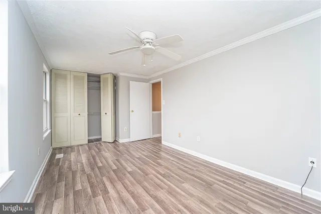 a view of an empty room with wooden floor