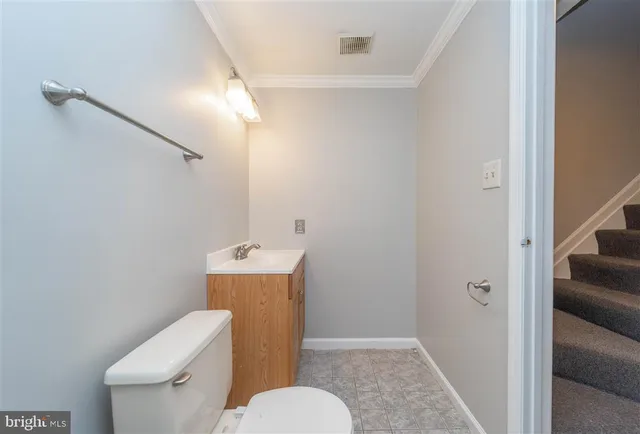 a white toilet sitting next to a bathroom sink