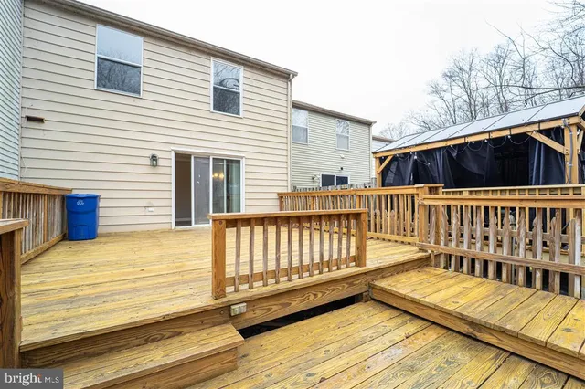a view of a house with wooden deck