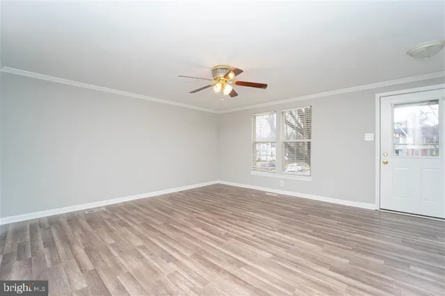 wooden floor in an empty room with a window