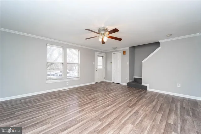 wooden floor in an empty room with a window