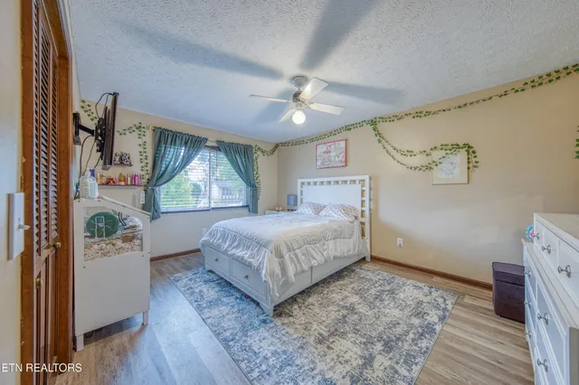 a bedroom with a large bed and a window