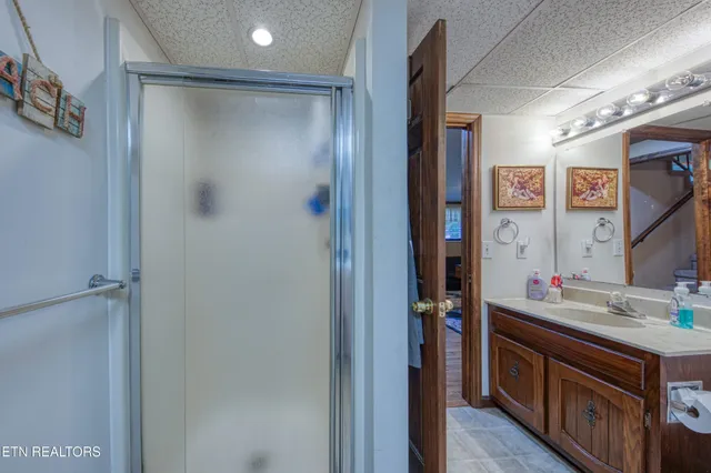a bathroom with a mirror sink and shower