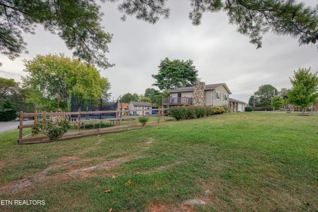 a house view with swimming pool and garden