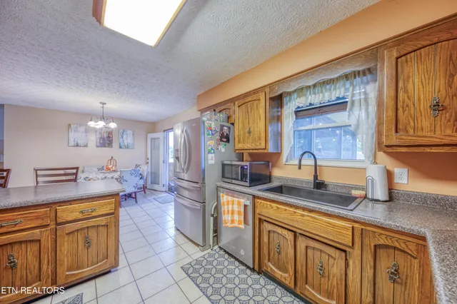 a kitchen with stainless steel appliances granite countertop a sink and cabinets