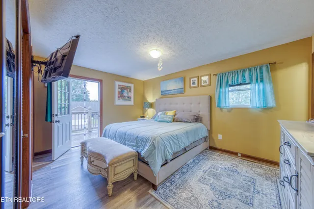 a bedroom with a bed wooden floor and a window