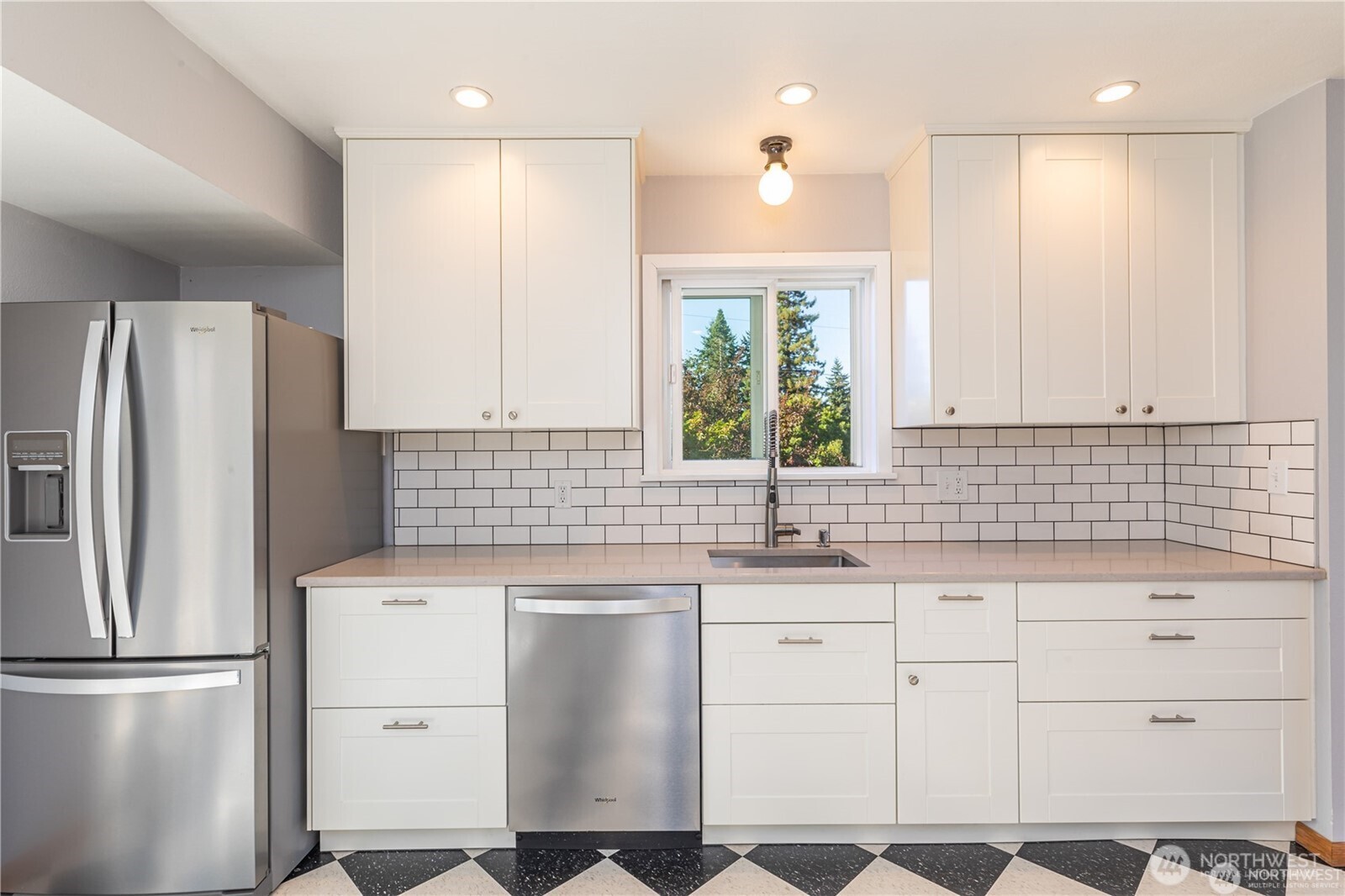 8601 36th Avenue Southwest Seattle, WA 98126 - Photo 10 of 28 a kitchen with white cabinets sink and refrigerator