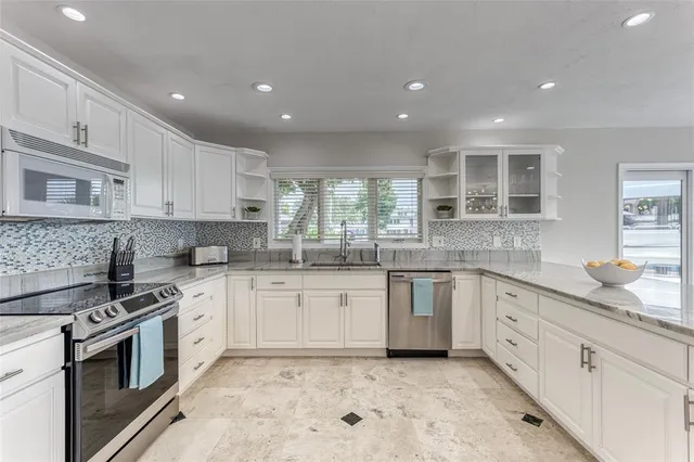 a spacious bedroom with a large bed and a large window