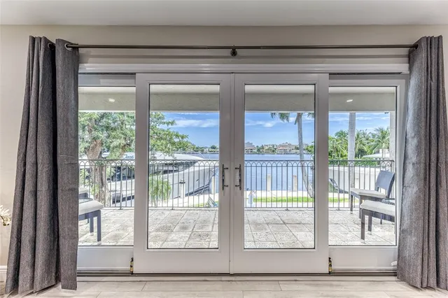 a spacious bedroom with a large bed and a large window