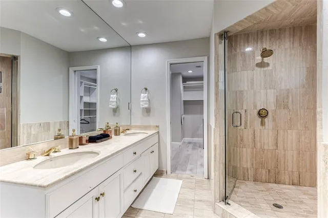 a bedroom with a bed a tv and wooden floor