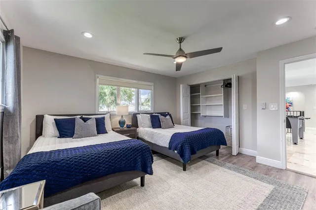 a bedroom with a large bed and a large window