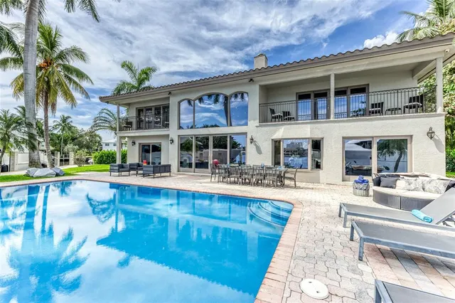 a view of a chairs and table in the patio with a swimming pool
