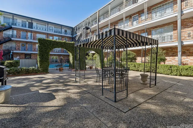 a view of a workspace with furniture and a bookshelf