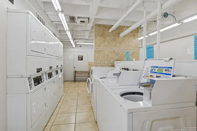 a room with sink cabinets and appliances