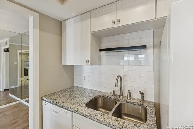a kitchen with a sink and cabinets