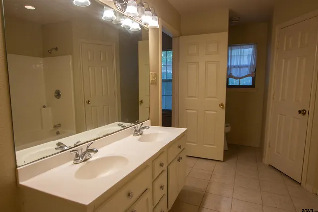 a bathroom with a sink double vanity and a mirror