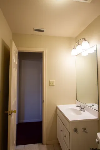 a bathroom with a double vanity sink and a mirror