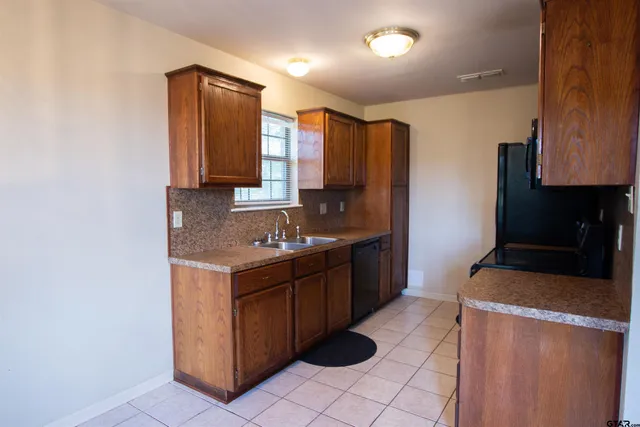 a kitchen with a sink cabinets and appliances