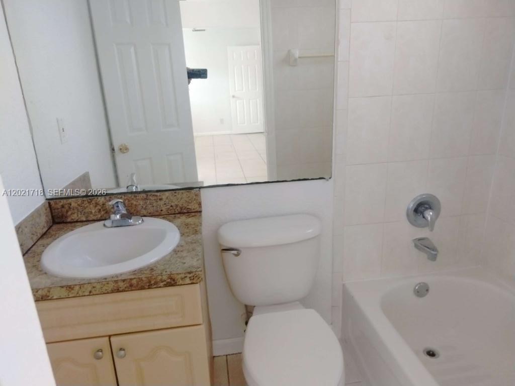 1021 West 2nd Street Riviera Beach, FL 33404 - Photo 4 of 8 a bathroom with a sink and a toilet