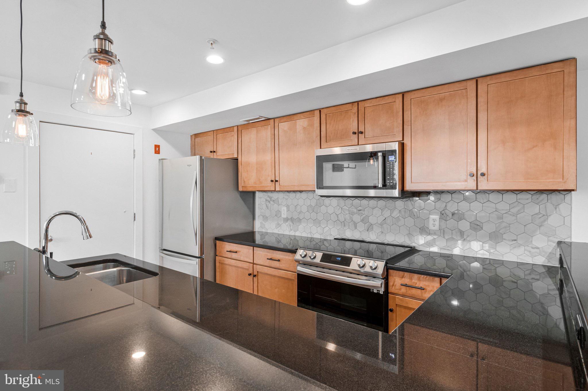 1240 4th Street Northwest, Unit T Washington, DC 20001 - Photo 7 of 28 Maple Wood cabinets with stainless steel appliance
