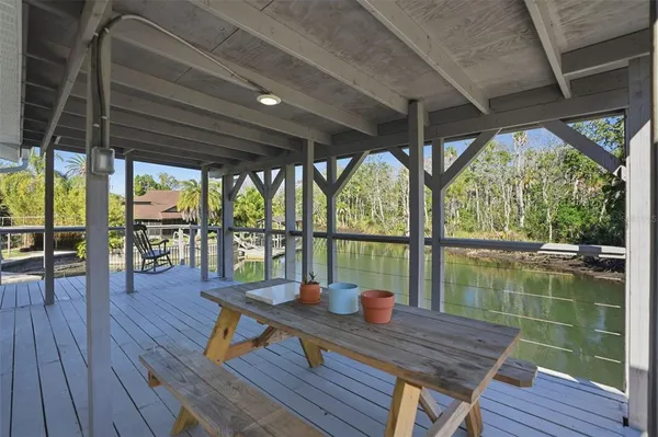 a view of a deck with wooden floor and outdoor seating