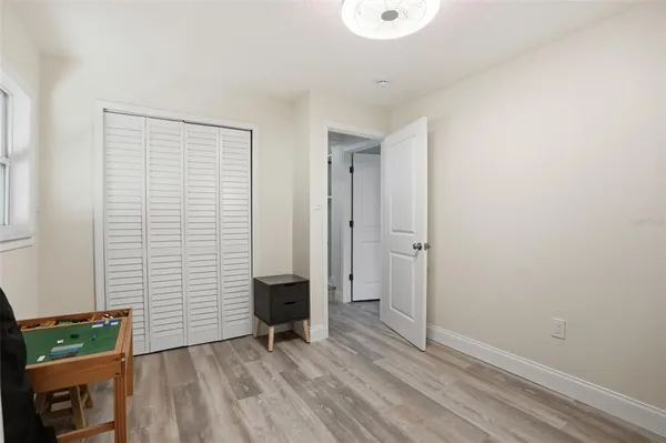 an empty room with wooden floor and a window