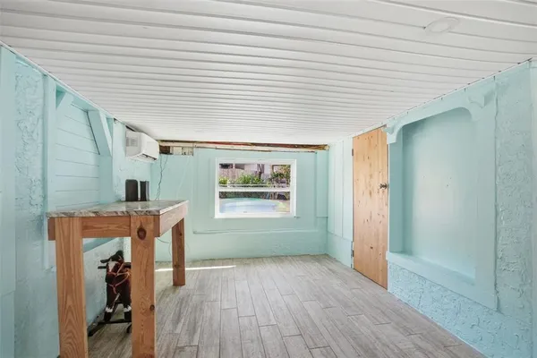 a view of room with window and wooden floor