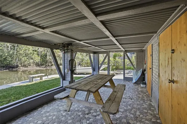 a view of a patio with chairs and floor to ceiling window