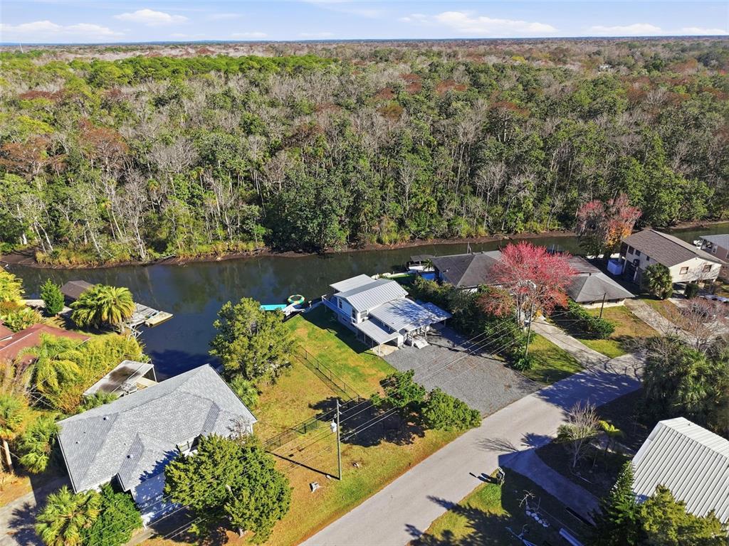 7266 Tropical Drive Weeki Wachee, FL 34607 - Photo 3 of 38 an aerial view of a house with a lake view