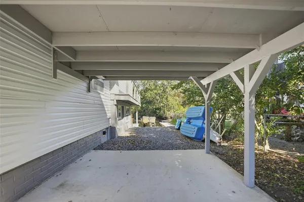 a view of a porch with furniture and floor to ceiling window
