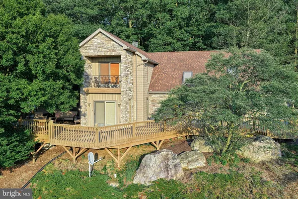 an aerial view of a house with swimming pool and garden