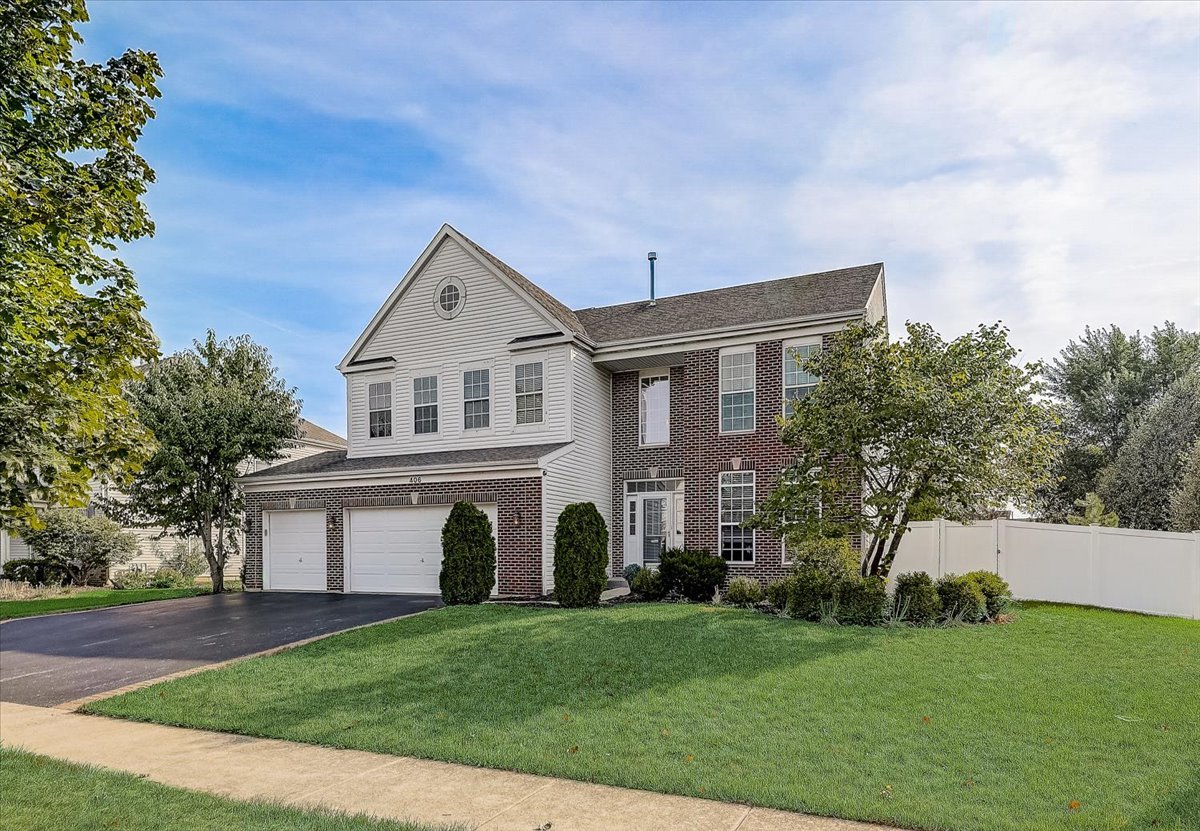 406 Aviary Lane Bolingbrook, IL 60490 - Photo 2 of 46 a front view of a house with a garden