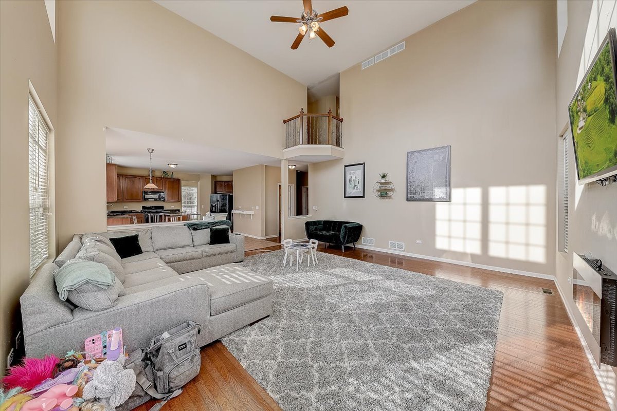406 Aviary Lane Bolingbrook, IL 60490 - Photo 19 of 46 a living room with furniture window and wooden floor