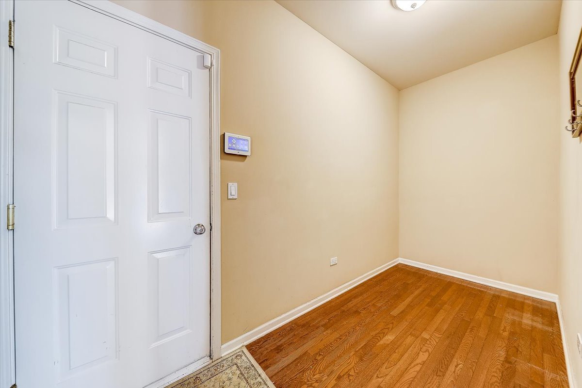 406 Aviary Lane Bolingbrook, IL 60490 - Photo 23 of 46 a view of a room with wooden floor and white walls