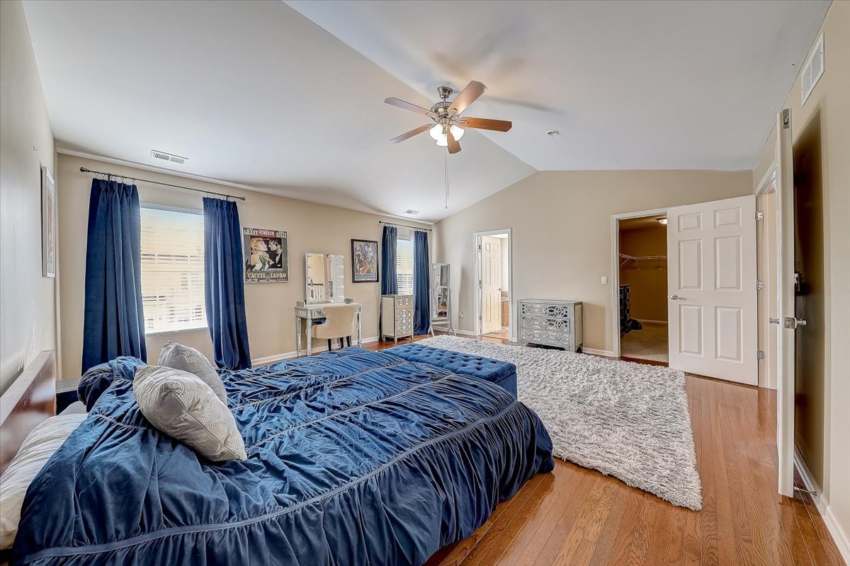 406 Aviary Lane Bolingbrook, IL 60490 - Photo 26 of 46 a bedroom with a large bed and a chandelier