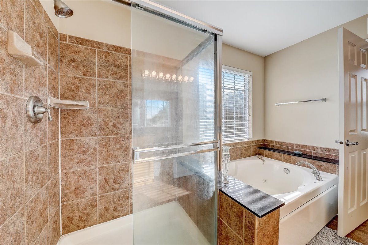 406 Aviary Lane Bolingbrook, IL 60490 - Photo 30 of 46 a bathroom with a tub a sink and a shower
